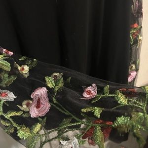 Shown size 4L black and floral shirt.
